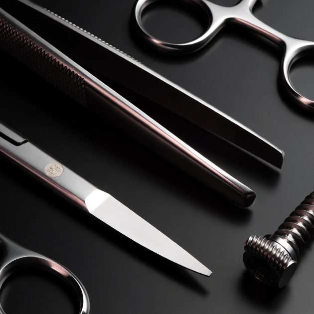Polished stainless steel surgical scissors, forceps, and implant screw representing AISI 440C, 420, and 316L steel grades — technical guide by Pintech Instruments Sialkot Pakistan